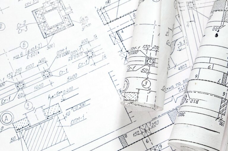 architect design working drawing sketch plans blueprints and making architectural construction model in architect studio,flat lay..